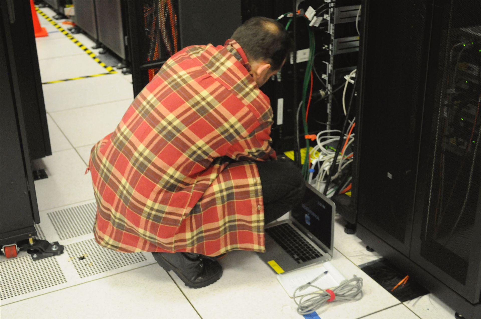 Technician working on server rack in a data centre