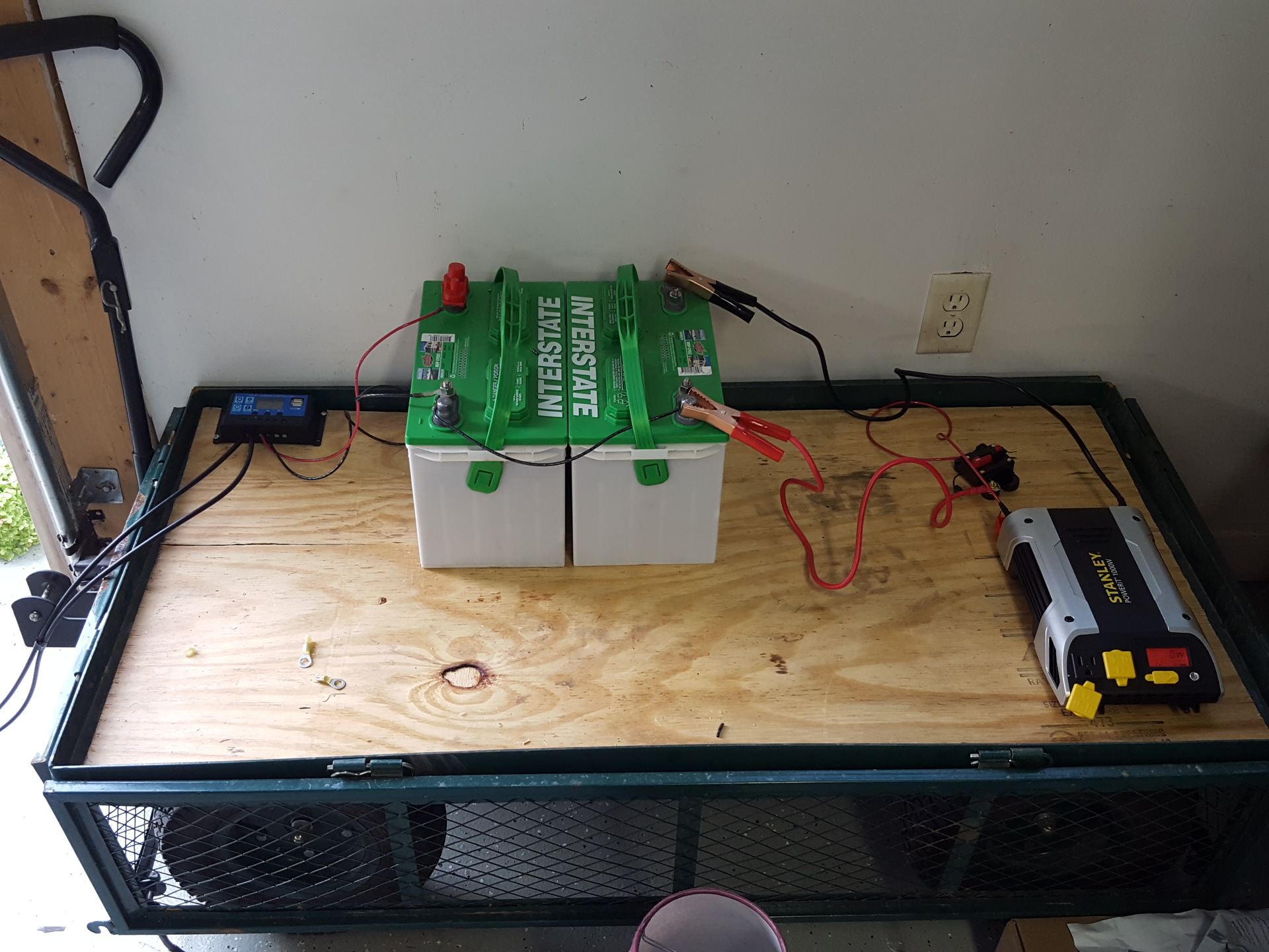 Complete off-grid solar system showing charge controller, battery bank, and inverter
